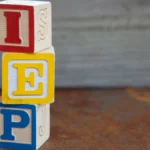 Stack of blocks on a table spelling out I E P